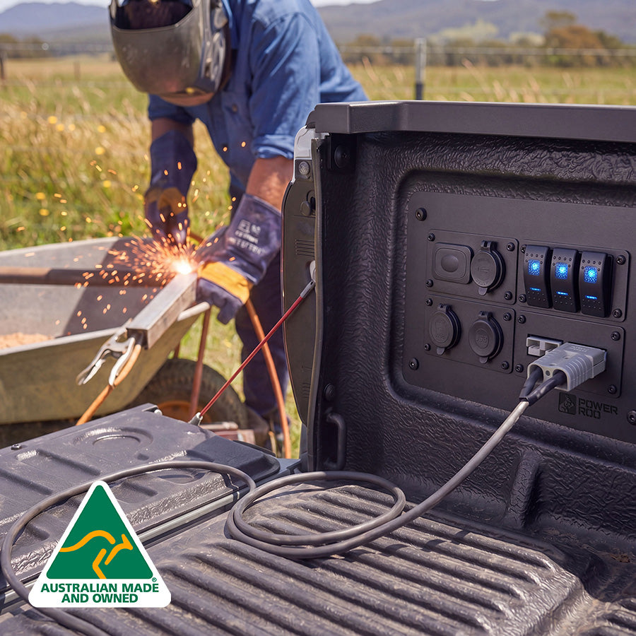 Person using a Ford Ranger power panel to weld outdoors with sparks flying